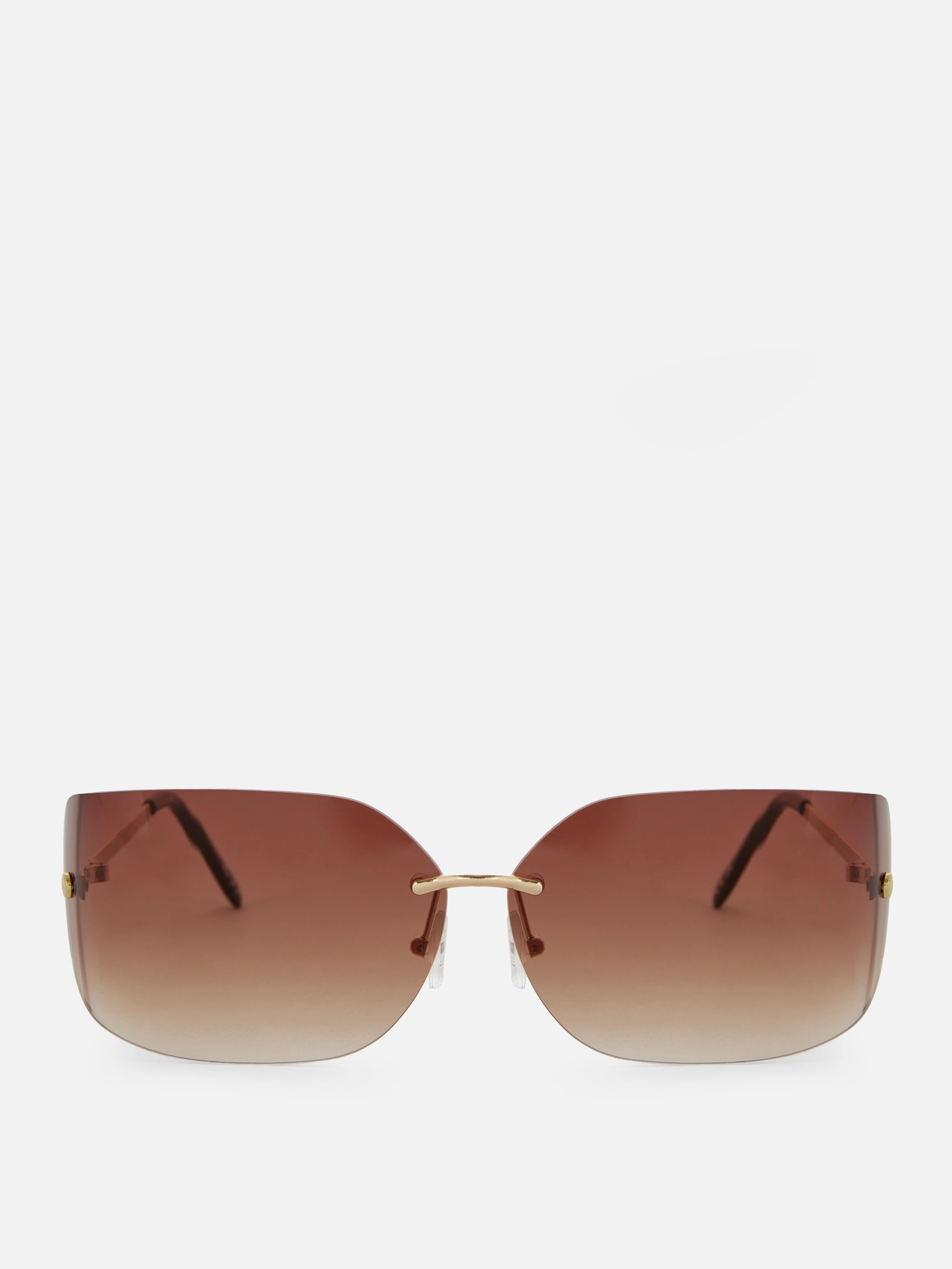 Gafas de sol de montura invisible curva de Rita Ora